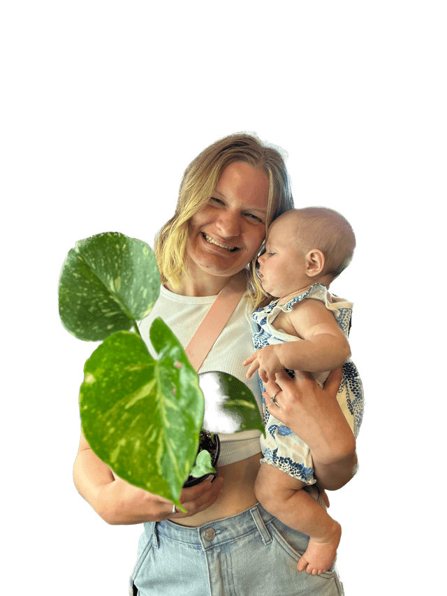 Picture of Hannah Stevens hold a plant and her daughter